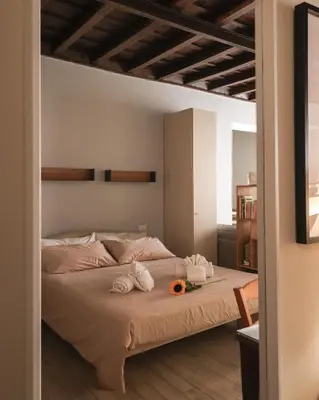 a bedroom with a bed with towels and flowers on it at Ciambella Cozy Flat in Rome