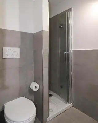 a bathroom with a toilet and a shower at Ciambella Cozy Flat in Rome