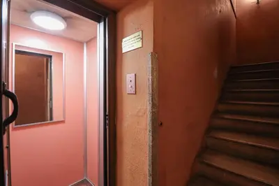 a hallway with a door and stairs in a building at Ciambella Cozy Flat in Rome