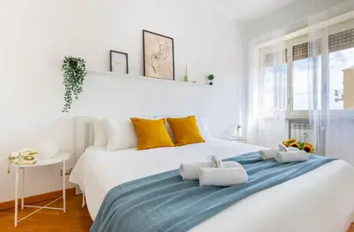 a white bedroom with a large bed with towels on it at Balduina Retreat Terrace in Rome