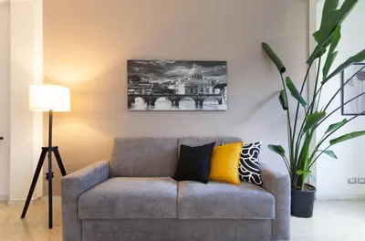 a living room with a couch and a painting on the wall at Balduina Retreat Terrace in Rome