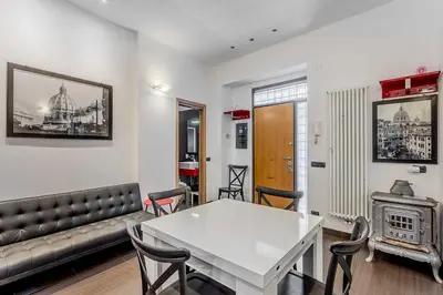 a living room with a white table and a couch at Vatican Bridge Home in Rome