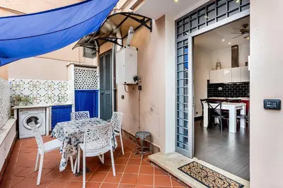 a kitchen and dining room with a table and chairs at Vatican Bridge Home in Rome