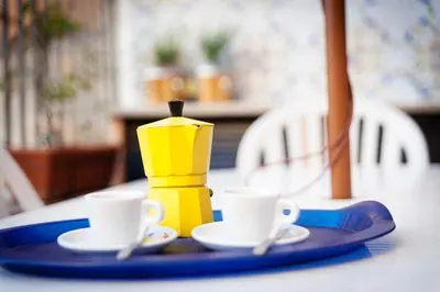 a table with two cups and a toy on a plate at Vatican Bridge Home in Rome
