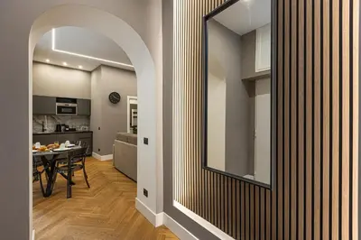 a hallway with a mirror and a dining room at Luxury Suite Coronari in Rome