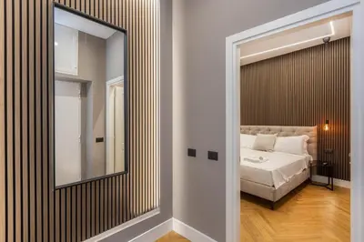 a bedroom with a mirror and a bed at Luxury Suite Coronari in Rome