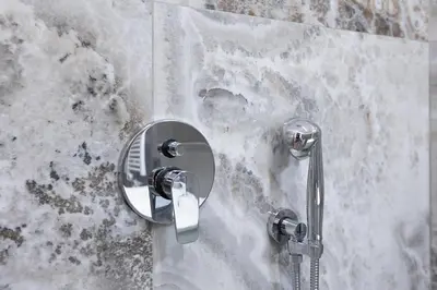 a shower with a shower head on a wall at Luxury Suite Coronari in Rome