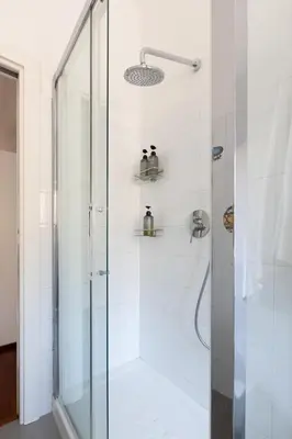 a bathroom with a shower with a glass door at Domus La Conca in Rome