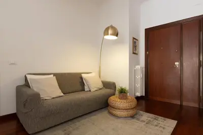 a living room with a couch and a table at Domus La Conca in Rome