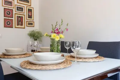 a dining room table with plates and wine glasses at Domus La Conca in Rome