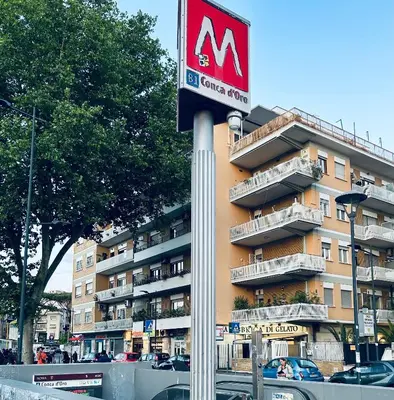 a sign on a pole in front of a building at Domus La Conca in Rome