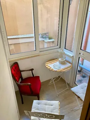 a room with a table and a chair and two windows at B&B trastevere il vicolo in Rome