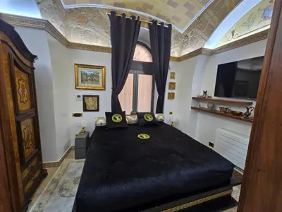 a bedroom with a large black bed with a window at The Etrurian Rapsody in Rome