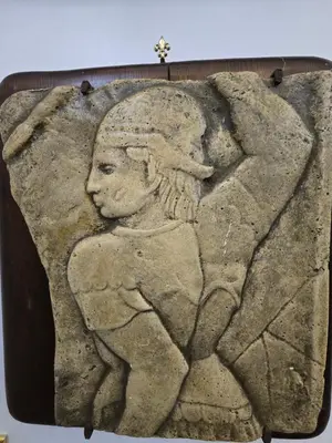 a stone relief of a woman on a rock at The Etrurian Rapsody in Rome
