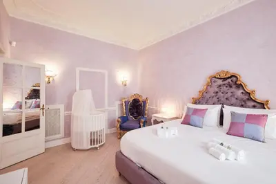a bedroom with a large white bed with purple walls at Luxury in Piazza di Spagna in Rome