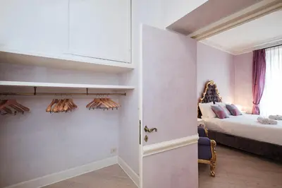 a small room with a bed and a room with a door at Luxury in Piazza di Spagna in Rome