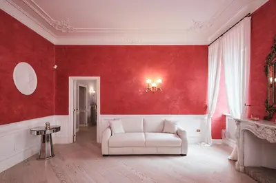 a living room with red walls and a white couch at Luxury in Piazza di Spagna in Rome
