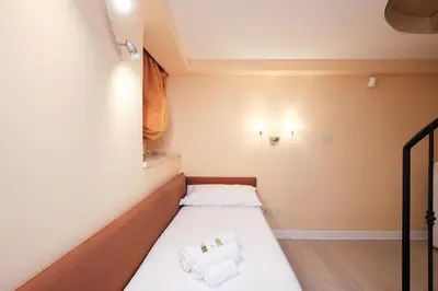 a small room with a bed with towels on it at Luxury in Piazza di Spagna in Rome