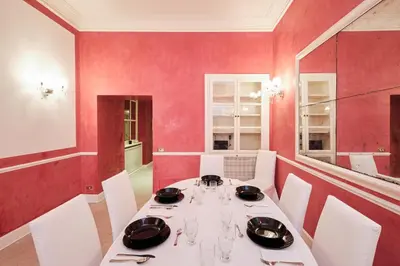 a dining room with a white table and red walls at Luxury in Piazza di Spagna in Rome