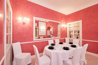 a dining room with a table and a mirror at Luxury in Piazza di Spagna in Rome