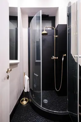 a bathroom with a shower with a glass door at Luxury in Piazza di Spagna in Rome