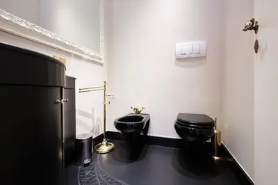 a bathroom with two toilets and a refrigerator at Luxury in Piazza di Spagna in Rome