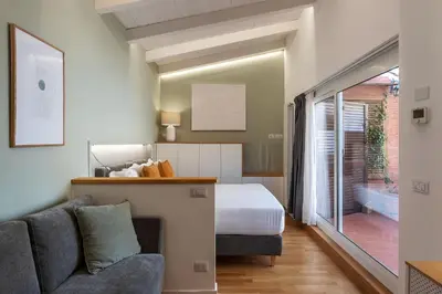 a bedroom with a bed and a couch in a room at Rasella 21 - FromHometoRome in Rome