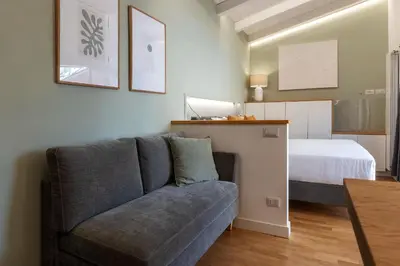 a living room with a couch and a bed at Rasella 21 - FromHometoRome in Rome