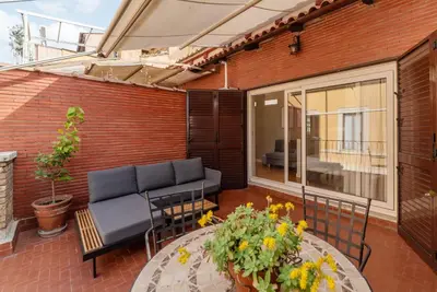 a patio with a couch and a table at Rasella 21 - FromHometoRome in Rome