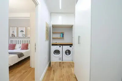 a hallway with a washer and dryer in a bedroom at Casilina 403 Spacious Apartment 3BDR and 3 BATH in Rome