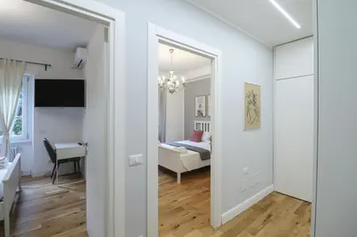 a room with a mirror and a bedroom with a bed at Casilina 403 Spacious Apartment 3BDR and 3 BATH in Rome