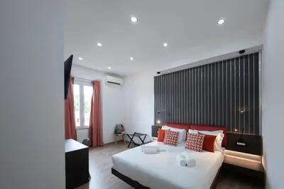 a bedroom with a large bed with red pillows at Trastevere New Luxury Rooms in Rome