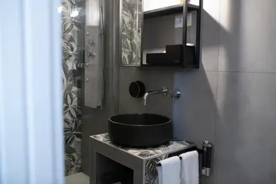 a bathroom with a sink and a mirror at Trastevere New Luxury Rooms in Rome