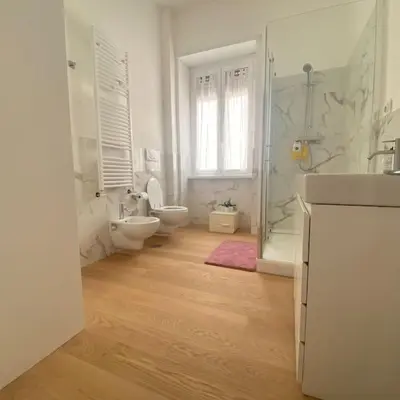 a bathroom with two toilets and a sink and a shower at Appartamento Villa Ada in Rome