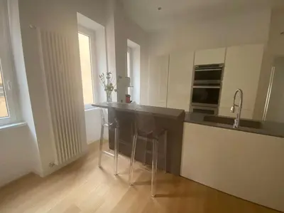 a kitchen with a counter with two stools in it at Appartamento Villa Ada in Rome