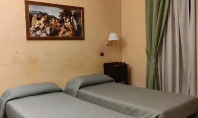 a room with two beds and a painting on the wall at Hotel MontReal in Rome