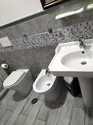 a bathroom with a toilet and a sink at Hotel MontReal in Rome