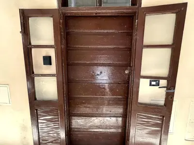 an old wooden door with glass panels in a room at Oasi Floreale - Roma Termini in Rome