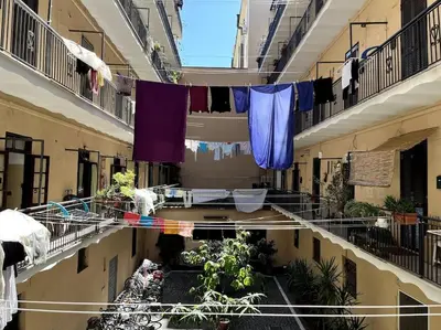 an apartment hallway with clotheslines and balconies in a building at Oasi Floreale - Roma Termini in Rome