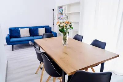 a dining room table with a vase of flowers on it at Casa Cornelia Station in Rome