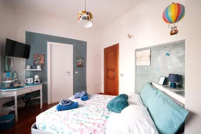 a bedroom with a bed and a desk and a computer at Interno 6 in Rome