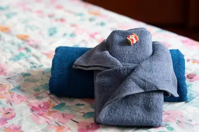 a pair of towels sitting on top of a bed at Interno 6 in Rome