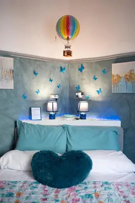 a bed with a heart pillow on top of it at Interno 6 in Rome