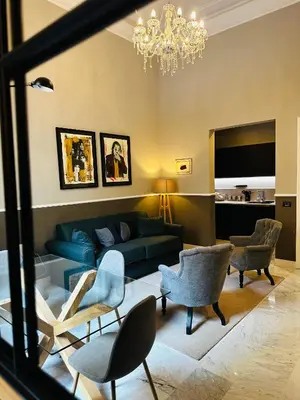 a living room with a blue couch and chairs at Via Veneto Luxury Maison in Rome