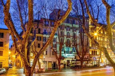 a building on a city street at night at Via Veneto Luxury Maison in Rome