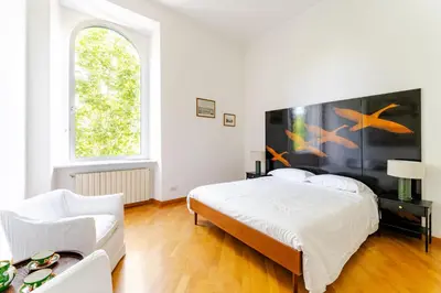 a white bedroom with a bed and a couch at Trastevere - Dolce Vita 4bedr 360 Terrace in Rome