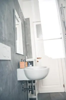 a bathroom with a white sink and a mirror at VILLA LINA - sky earth liberty villa - 5 min from tube in Rome