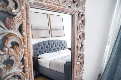 a mirror reflecting a bed in a bedroom at VILLA LINA - sky earth liberty villa - 5 min from tube in Rome