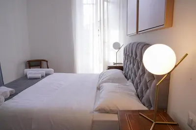 a bedroom with a large bed and a lamp at VILLA LINA - sky earth liberty villa - 5 min from tube in Rome