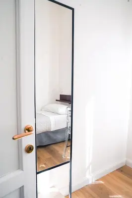 a mirror in a bedroom with a bed at VILLA LINA - sky earth liberty villa - 5 min from tube in Rome